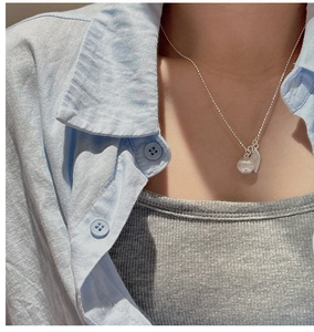 Close-up of S925 sterling silver beaded necklace with clear apple bead and leaf pendant