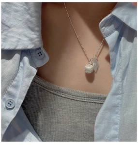 Detail of S925 sterling silver beaded necklace with textured sphere and leaf pendant