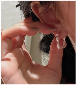 Close-up of minimalist S925 sterling silver square hoop earrings with matte finish