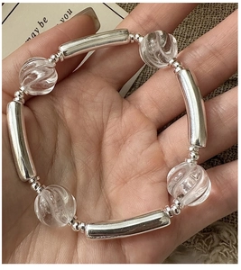 Detail view of S925 silver beaded bracelet with clear crystal beads and curved metal tubes