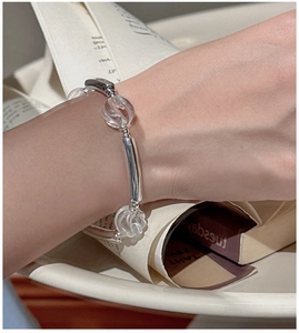 Detail of S925 silver bracelet with textured white crystals on a book background
