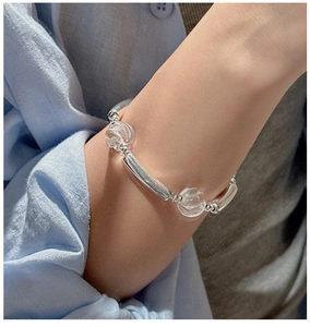 Close-up of minimalist S925 sterling silver beaded bracelet with clear crystal accents
