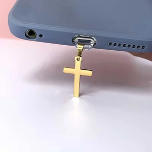 Detailed view of a golden stainless steel cross pendant with transparent phone case card