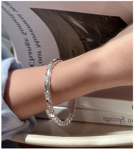 Macro view of S925 sterling silver segmented bracelet with inlaid cubic zirconia stones