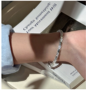 Detailed view of an S925 silver bracelet with geometric segments and zircon stones