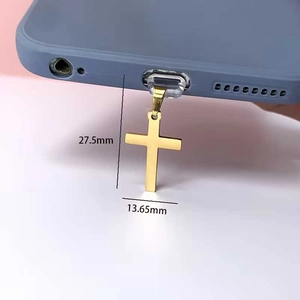 Golden stainless steel cross phone charm and dust plug with sleek metallic texture
