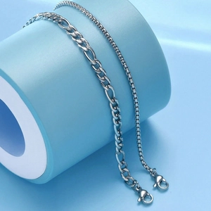 Minimalist double chain silver bracelets featuring Figaro and box styles on display