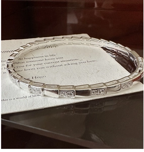 Detail shot of S925 silver bracelet featuring snake scale patterns and cubic zirconia stones