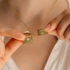 Gold envelope pendant necklace with hidden Love You engraved insert on a female model