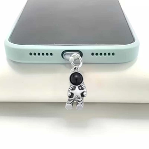 Silver astronaut phone dust plug charm for mobile case with detailed metallic finish