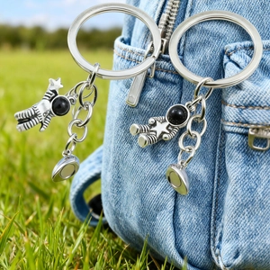 Astronaut magnetic couple keychain set on denim bag with silver astronaut charms