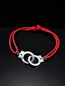 Macro view of adjustable red woven cord bracelet with silver interlocking handcuffs