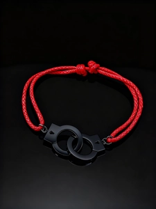 Close-up of bright red braided leather cord with interlocking black handcuff charms