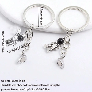 Macro detail of magnetic astronaut keychains showing precise size measurements and silver finish