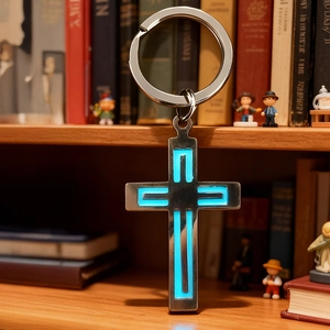 Detailed close-up of a luminous blue cross keychain standing on a wooden shelf