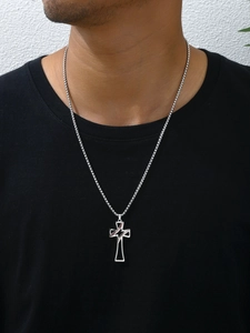Macro detail of silver baseball cross pendant with red stitching on box chain