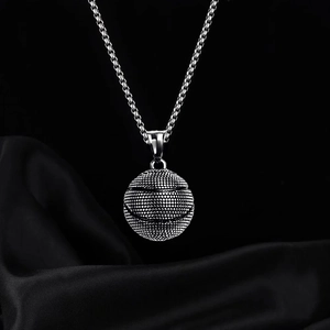 Detailed close-up of a basketball pendant necklace with textured surface and box chain link