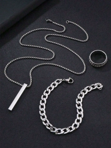 Close-up of silver men's jewelry set with bar necklace, Cuban bracelet and textured ring