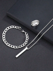Detail of silver stainless steel men jewelry set with curb chain and geometric pendant