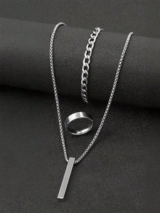 Detail view of silver stainless steel jewelry set with bar pendant, chain and wide band ring