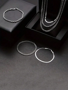 Detail view of silver stainless steel jewelry set with rope, curb, and snake chains