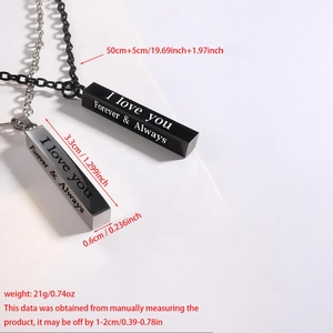 Macro shot of I LOVE YOU engraved bar pendant in polished black and silver steel