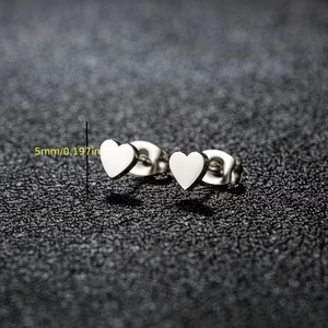 Minimalist silver heart stud earrings with white enamel finish and butterfly backs