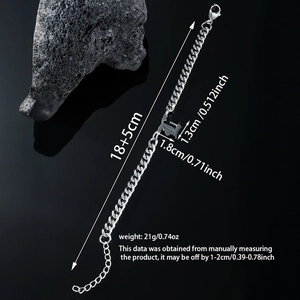 Macro view of silver Cuban chain bracelet with Gothic letter L pendant and lobster clasp