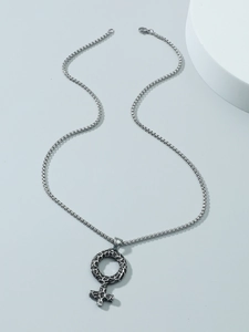 Macro detail of vintage Nordic Viking necklace with textured round symbol pendant