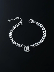 Silver Cuban link bracelet featuring a Gothic U-letter pendant and lobster clasp