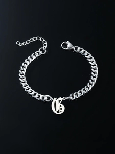 Detailed view of silver stainless steel Cuban link bracelet with Gothic letter G pendant