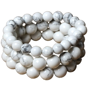Detailed view of three-piece set of white marble pattern beaded stretch bracelets
