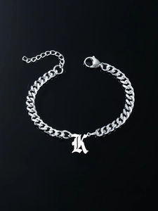 Macro shot of Cuban chain bracelet with Gothic K pendant and adjustable lobster clasp