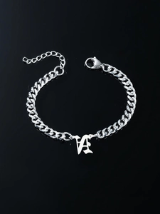 Detailed macro of silver Cuban chain bracelet with Gothic LA pendant and lobster clasp