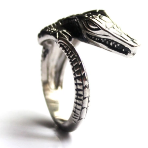 Macro shot of vintage crocodile ring with textured scales and retro black finish