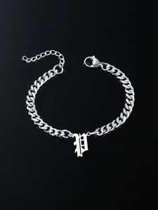 Detail of silver Cuban link bracelet with a Gothic letter P pendant and lobster clasp