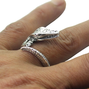 Close-up detail of vintage silver crocodile open ring showing fine scale texture on hand