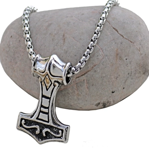 Vintage Thor's Hammer Mjolnir pendant necklace in silver stainless steel on grey stone