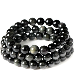 Detailed view of triple-wrap black obsidian beaded bracelet with rainbow eye effect