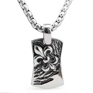 Macro shot of vintage fleur-de-lis embossed square pendant and silver box chain