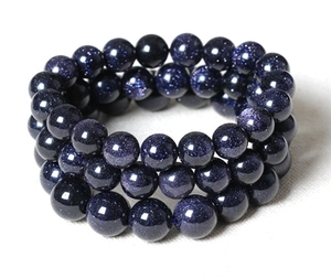 Macro shot of deep blue goldstone beaded multi-layer bracelet with sparkling stars finish