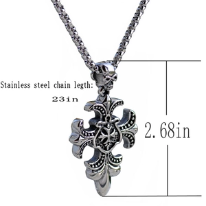 Detail of stainless steel gothic cross pendant with skull bail and fleur-de-lis accents