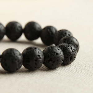 Minimalist black lava stone beaded bracelet with natural porous texture for daily wear