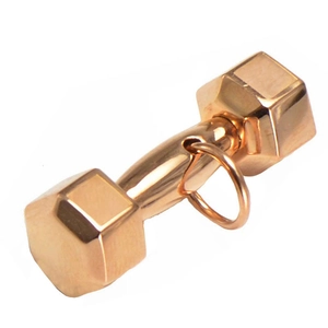 Detailed close-up of rose gold dumbbell pendant with polished hexagonal ends and jump ring