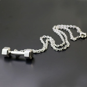 Close-up of a silver stainless steel fitness dumbbell pendant with a matching chain necklace