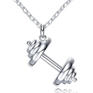 Macro shot of silver dumbbell pendant with detailed plates on a fine link chain necklace