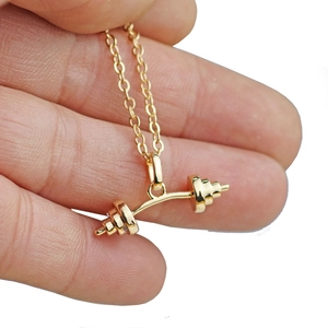 Golden barbell pendant necklace for fitness lovers with detailed weight plate design