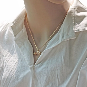 Golden fitness dumbbell pendant necklace on model showcasing minimalist gym jewelry style