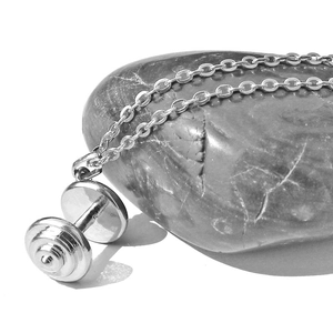 Polished silver barbell pendant necklace on stone background for fitness enthusiasts