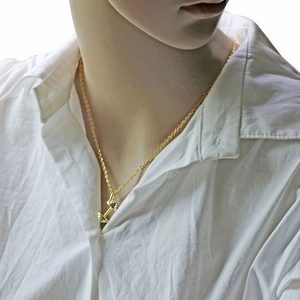 Golden dumbbell pendant necklace for women shown on a model with white shirt